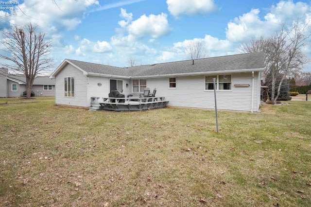 back of property with a lawn and a wooden deck