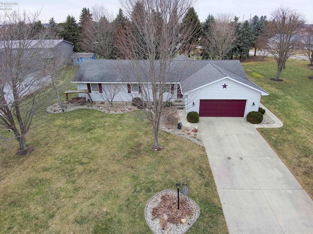 ranch-style home featuring a garage, a front yard, driveway, and a shingled roof