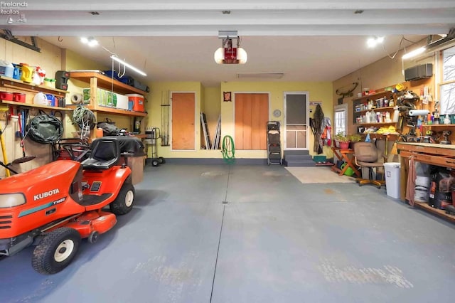 garage with a workshop area and a garage door opener