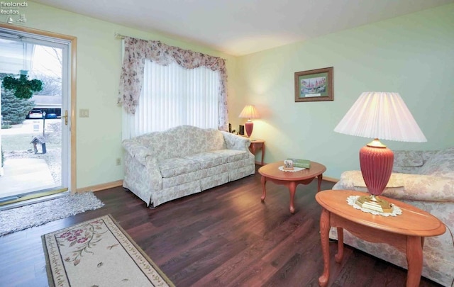 living room featuring baseboards and wood finished floors