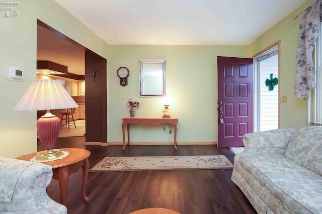 foyer featuring baseboards and wood finished floors