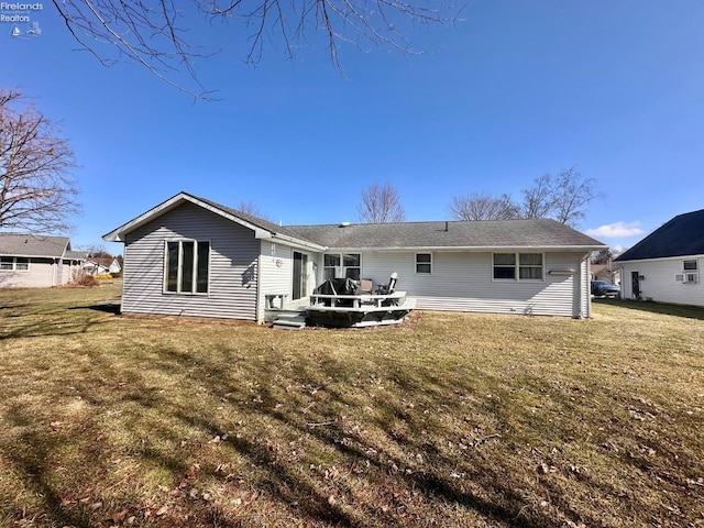 rear view of property with a yard