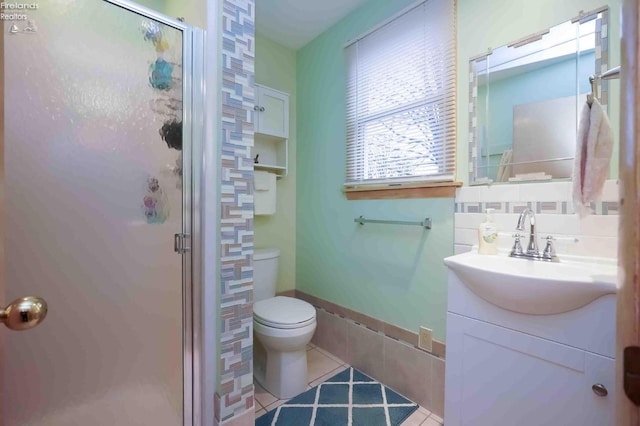 bathroom with a stall shower, tile patterned flooring, backsplash, and toilet