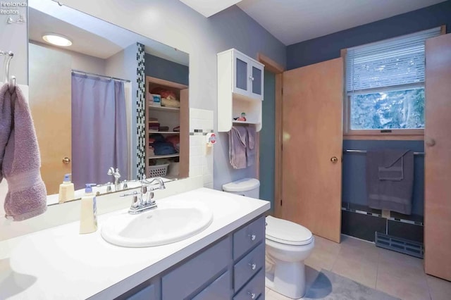 full bathroom with a shower with shower curtain, vanity, toilet, and tile patterned floors