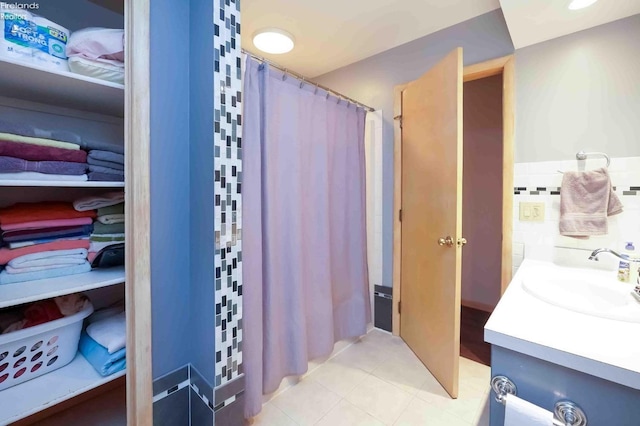 bathroom featuring tile patterned flooring, vanity, and a shower with shower curtain