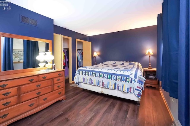 bedroom with dark wood-style flooring and visible vents