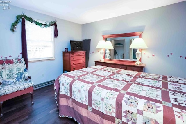 bedroom with dark wood-style floors and a baseboard radiator