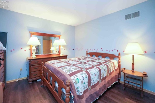 bedroom featuring dark wood-type flooring, visible vents, and baseboards