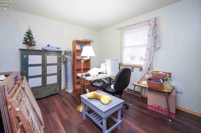 office featuring visible vents, baseboards, and wood finished floors