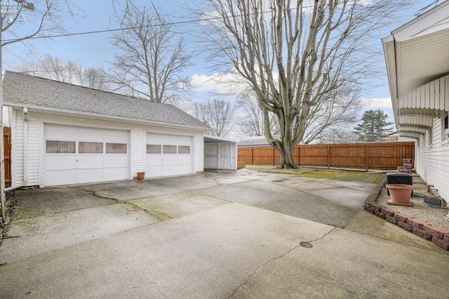 detached garage featuring fence