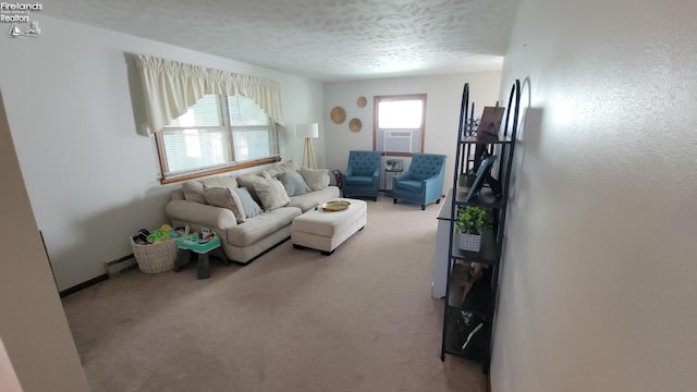 carpeted living room featuring a baseboard heating unit, cooling unit, and a textured ceiling