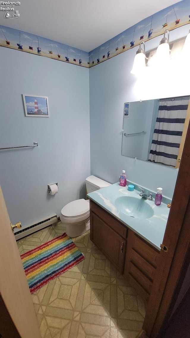 full bath with a baseboard radiator, vanity, and toilet