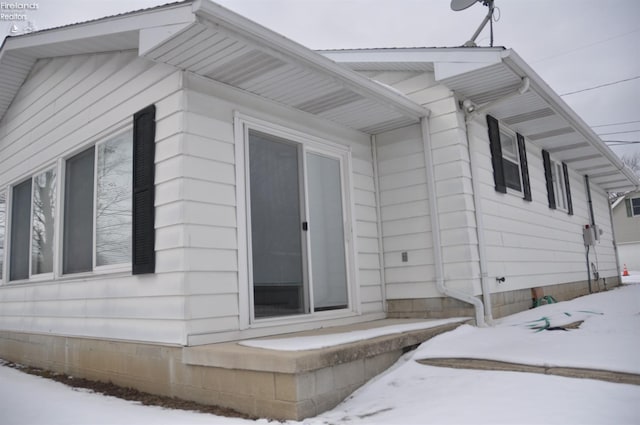 view of snow covered property entrance