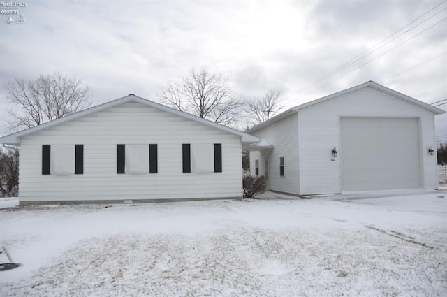 view of front facade with a garage and an outbuilding