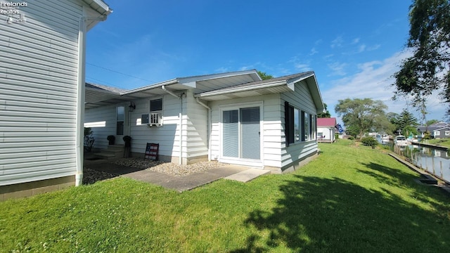 back of property featuring cooling unit, a yard, and fence