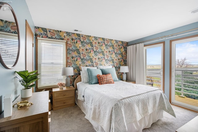 bedroom with carpet, visible vents, and wallpapered walls