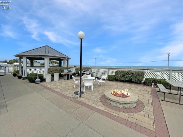 view of patio featuring an outdoor fire pit, a grill, and a gazebo