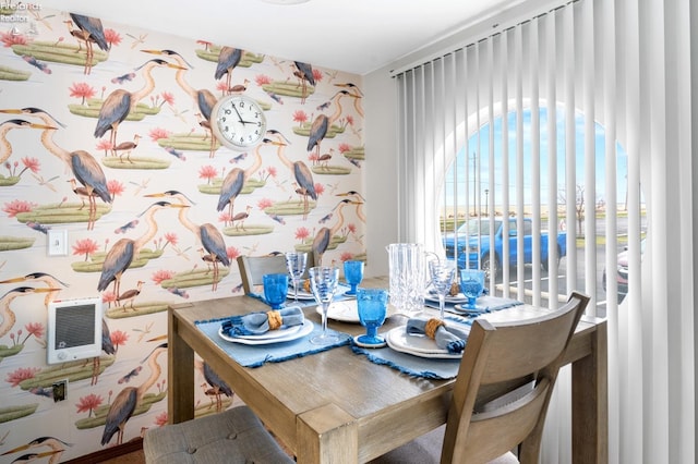 dining area featuring wallpapered walls