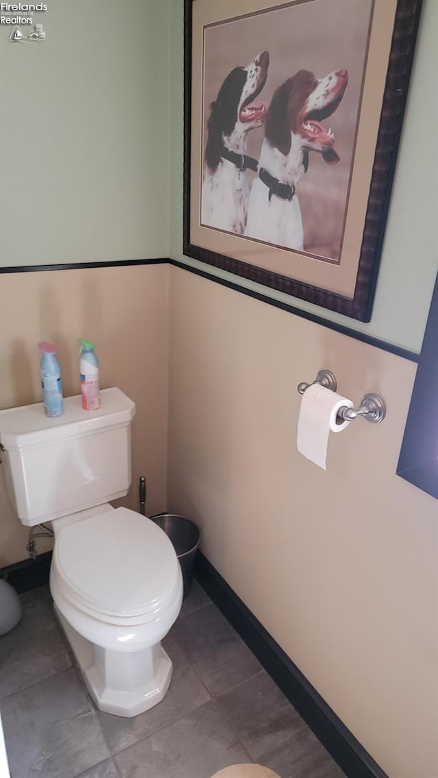 bathroom featuring tile patterned floors, toilet, and baseboards