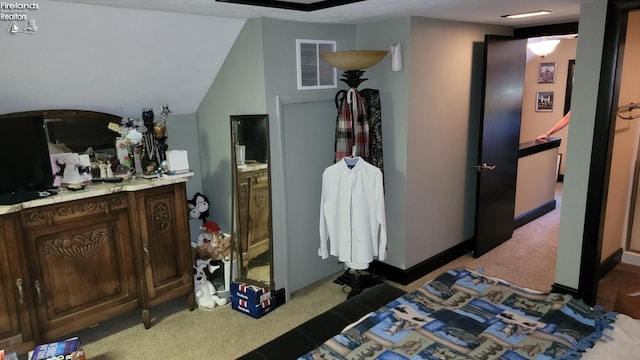 bedroom featuring baseboards, visible vents, and light colored carpet