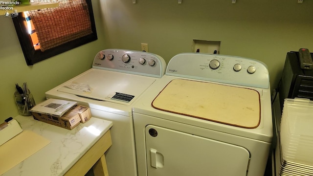 clothes washing area featuring laundry area and washing machine and dryer