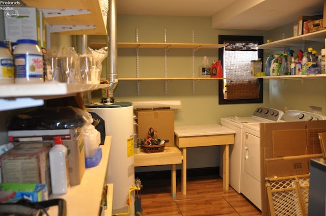 interior space featuring washer and dryer, laundry area, water heater, and wood finished floors