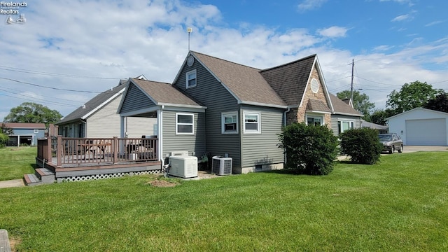 exterior space featuring an outbuilding, a yard, a wooden deck, and central AC unit