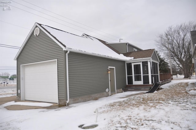 view of snow covered exterior featuring a sunroom