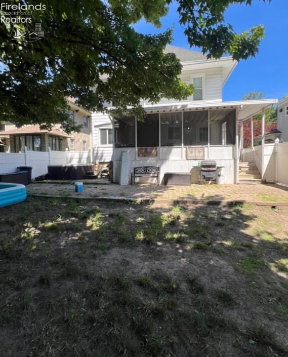 view of front of house featuring a sunroom and fence