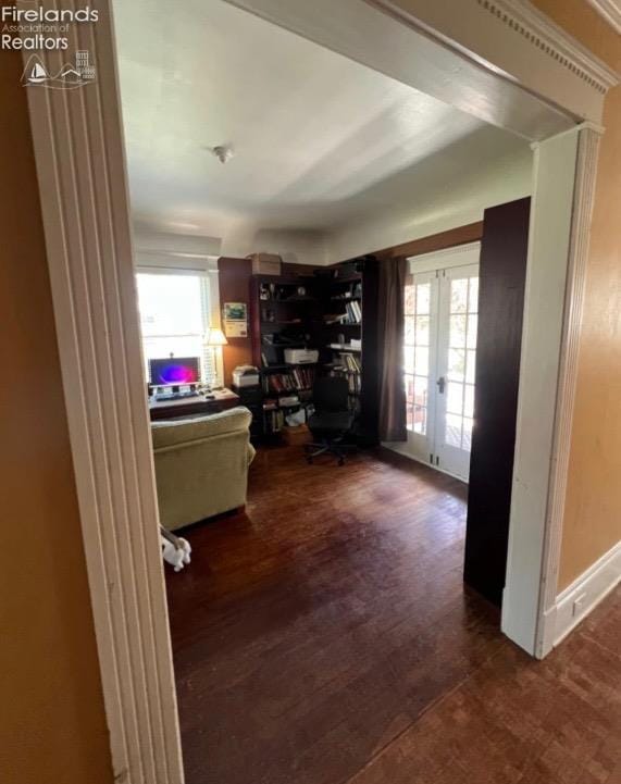 home office with plenty of natural light, baseboards, dark wood-style flooring, and french doors