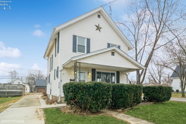 american foursquare style home featuring an outbuilding