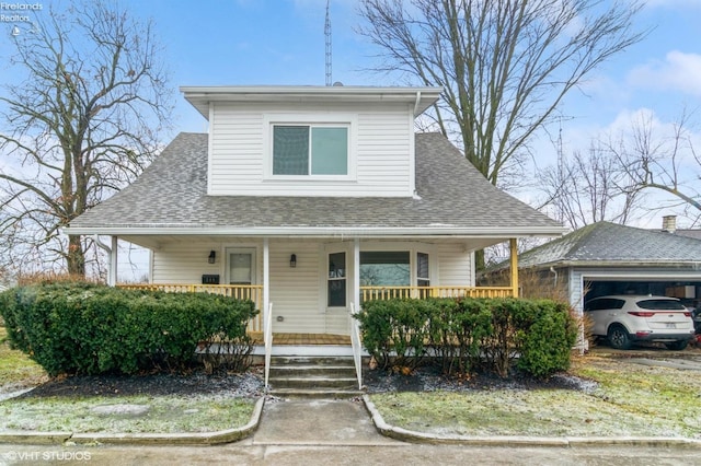 bungalow-style house with a porch and roof with shingles