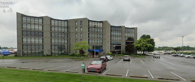 view of building exterior with uncovered parking