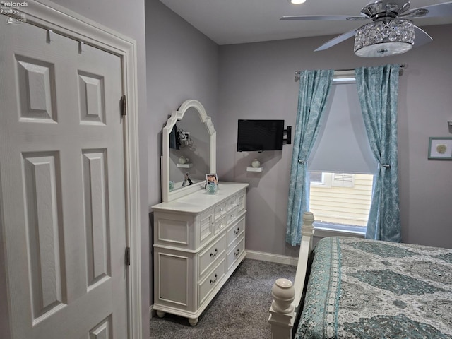 bedroom featuring dark colored carpet, a ceiling fan, and baseboards