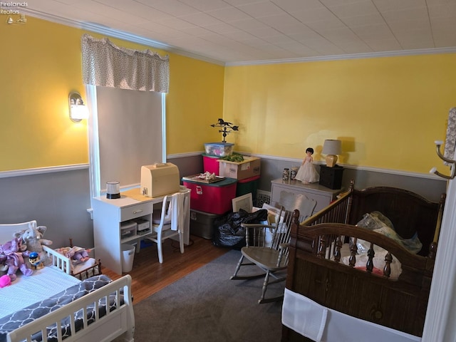 bedroom featuring crown molding and wood finished floors