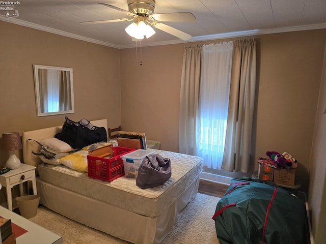 bedroom featuring ceiling fan and ornamental molding