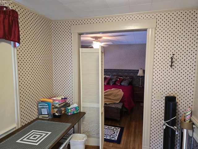 bedroom featuring ornamental molding and wood finished floors