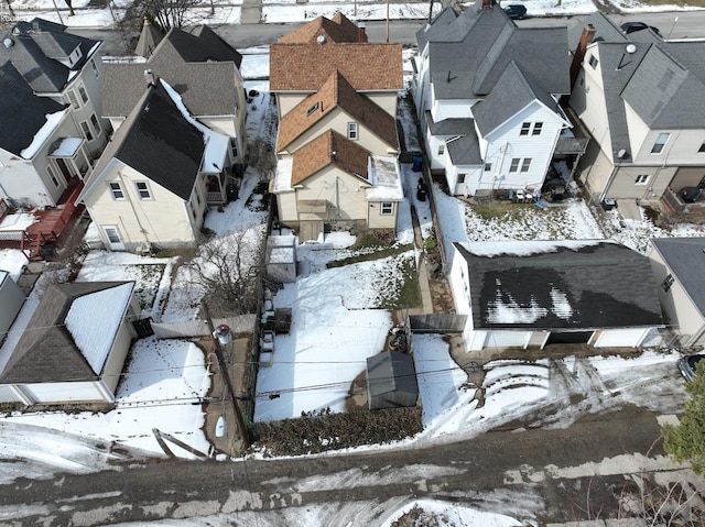 snowy aerial view featuring a residential view