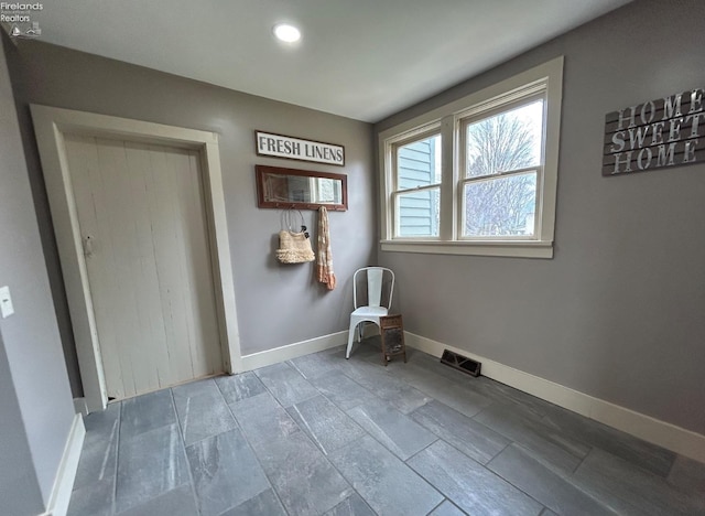 unfurnished room featuring recessed lighting, visible vents, and baseboards