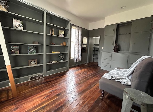 living area featuring dark wood-style floors and visible vents