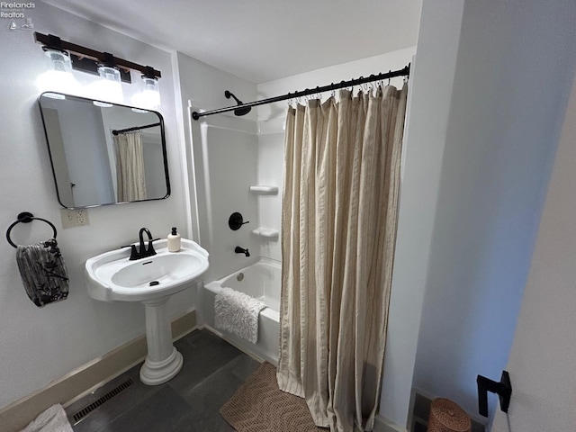 bathroom featuring a sink, shower / bath combination with curtain, and visible vents