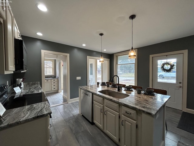 kitchen featuring electric range, stone countertops, a kitchen island with sink, stainless steel dishwasher, and a sink