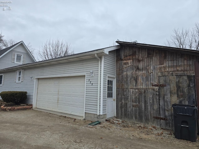 view of side of property featuring a garage and driveway