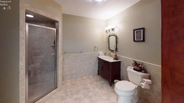 1876 N Lakewood Ave, Port Clinton, OH 43452 - full bath featuring toilet, a wainscoted wall, a shower stall, and tile walls