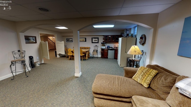 1876 N Lakewood Ave, Port Clinton, OH 43452 - interior space featuring a paneled ceiling, visible vents, baseboards, freestanding refrigerator, and carpet