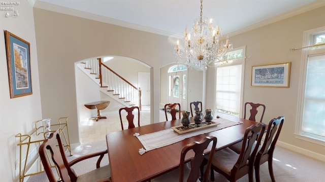 1876 N Lakewood Ave, Port Clinton, OH 43452 - carpeted dining room featuring ornamental molding, arched walkways, and a healthy amount of sunlight