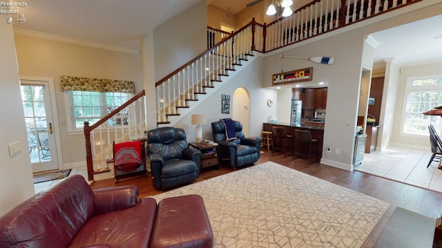 1876 N Lakewood Ave, Port Clinton, OH 43452 - living room with baseboards, arched walkways, stairway, wood finished floors, and crown molding