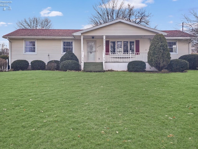 ranch-style house featuring a porch and a front lawn