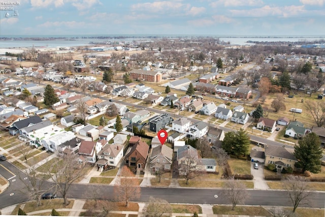 drone / aerial view featuring a residential view and a water view