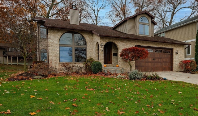 view of front of home with driveway, a front yard, a chimney, and brick siding